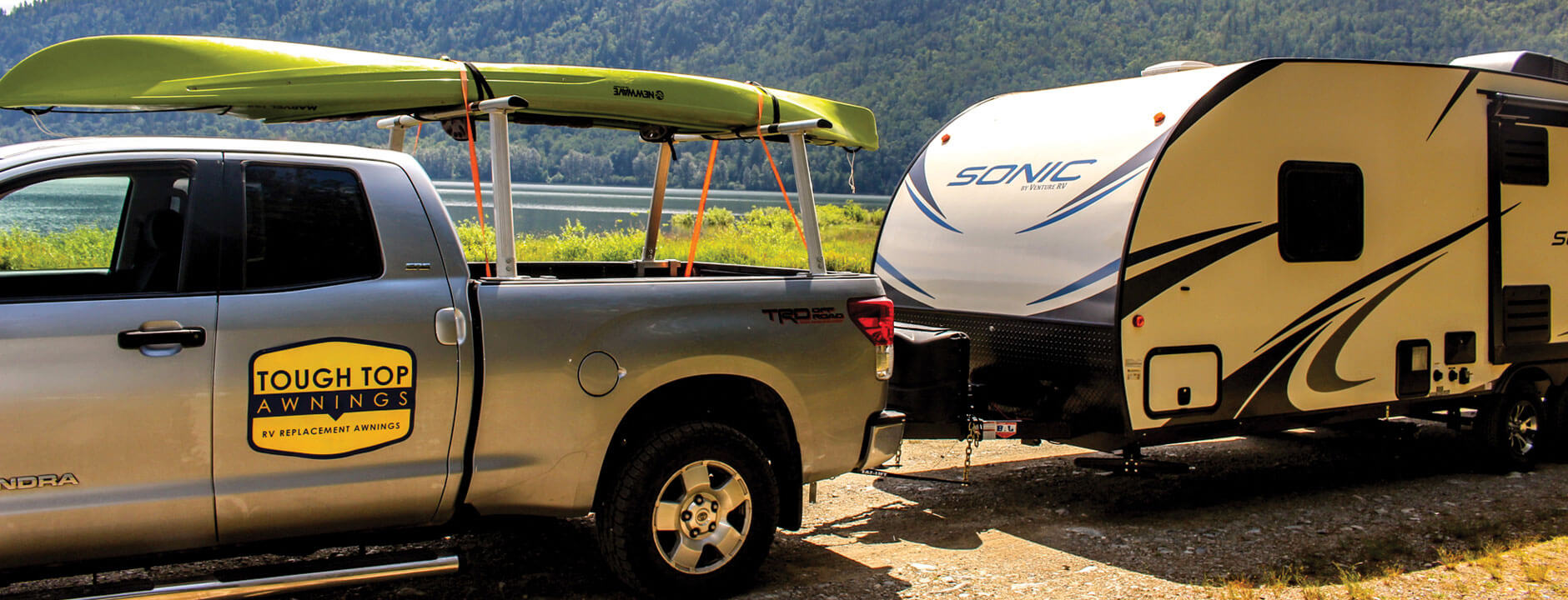 Tough Top Awning truck camping with travel trailer, with kayak on top at the river
