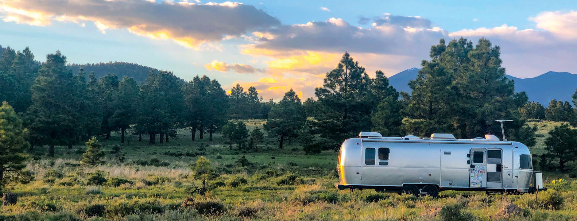 Airstream camping in the mountains with sunset